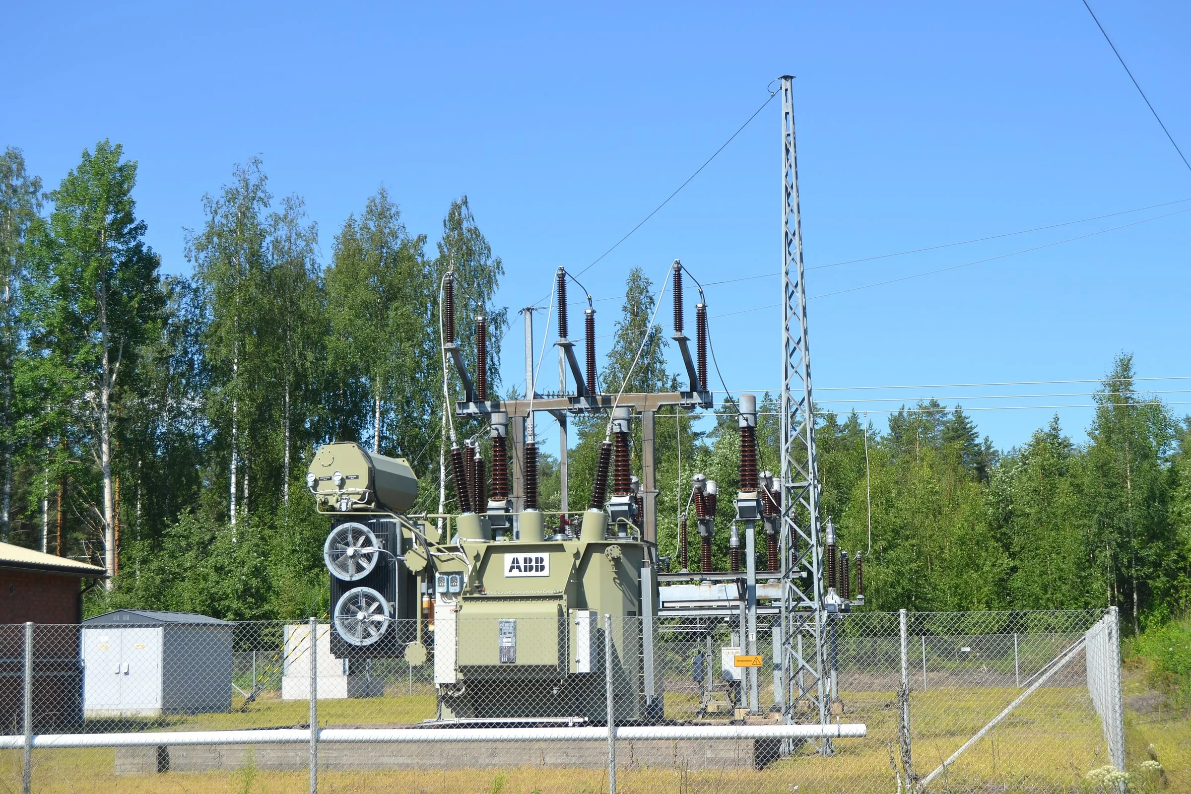 Three-phase distribution transformer and low-voltage switchgear at a North American facility substation