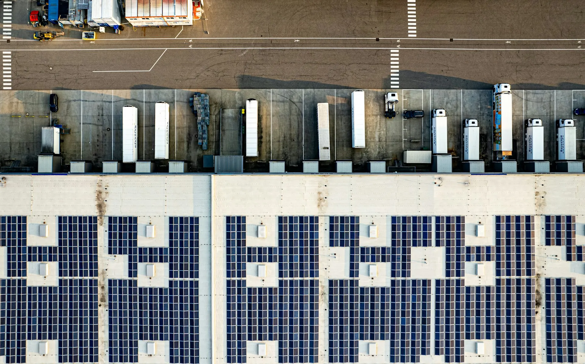 Commercial rooftop solar array paired with a battery energy storage system, illustrating DC-coupled versus AC-coupled solar-plus-storage architecture