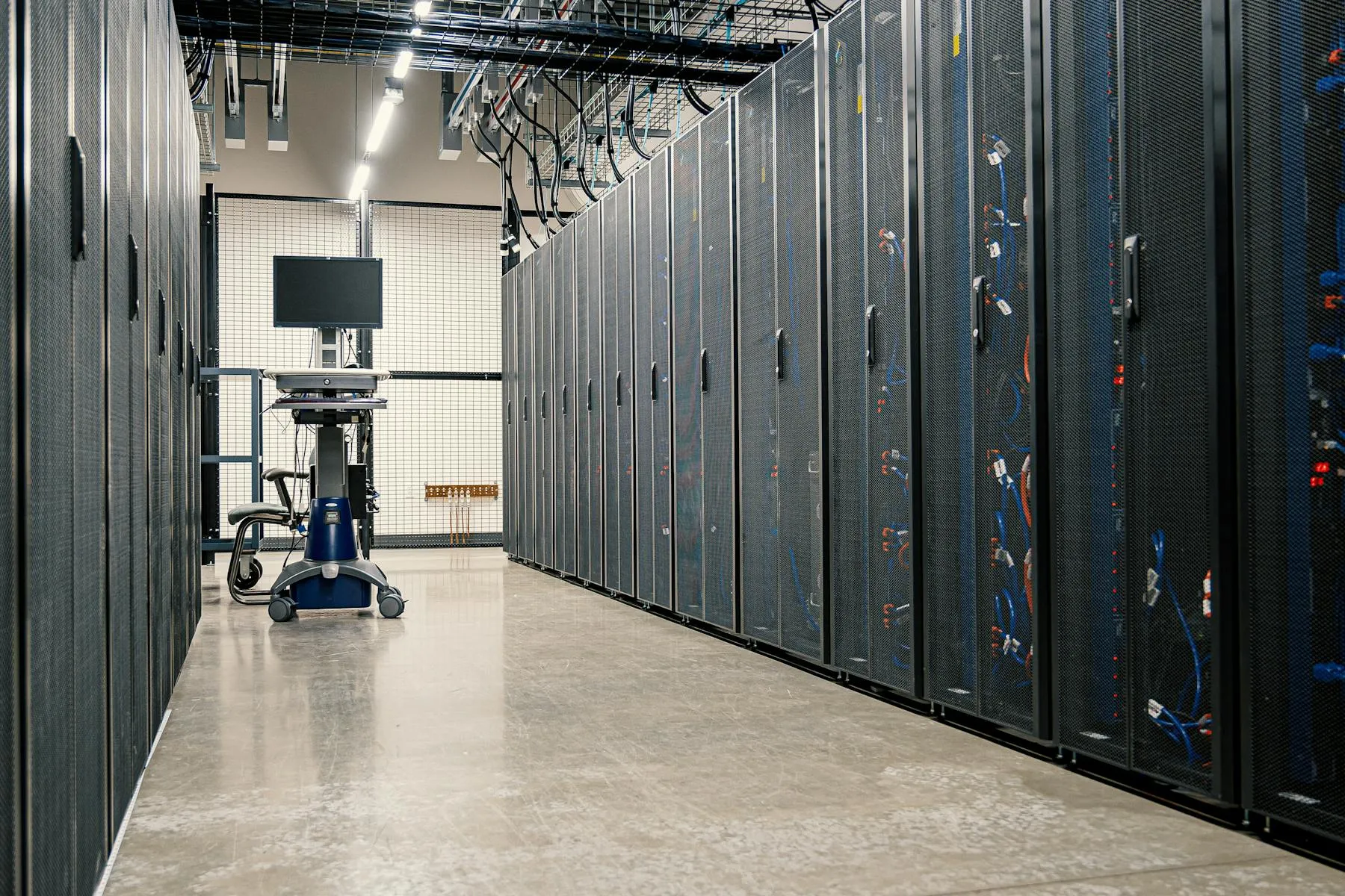 Hyperscale data-center server rack hall with cabling and aisle — Entogo power-equipment customer environment for AI and cloud loads